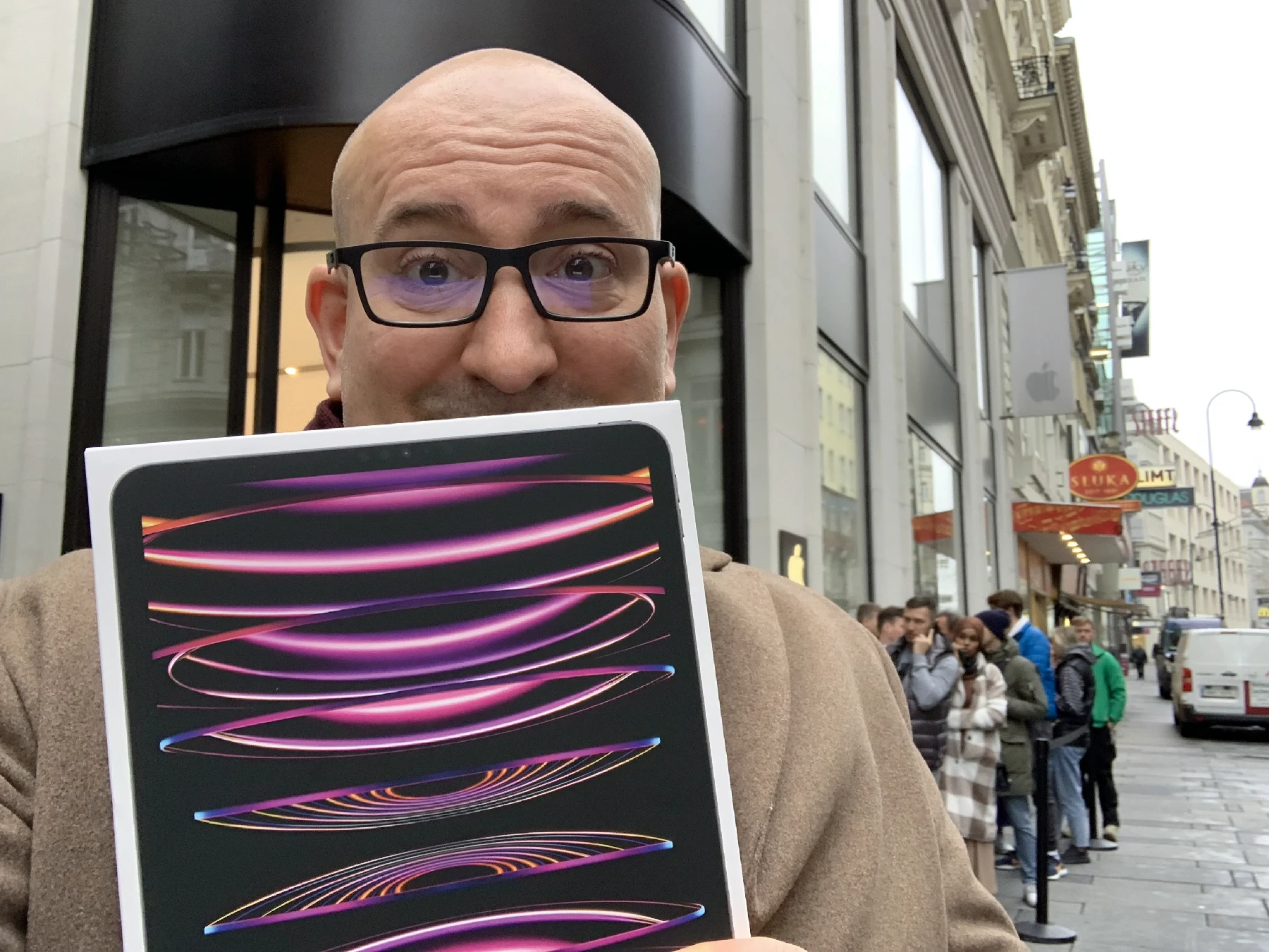 Marin holding his newly purchased and still boxed iPad Pro with an M2 chip, used for drawing with Procreate