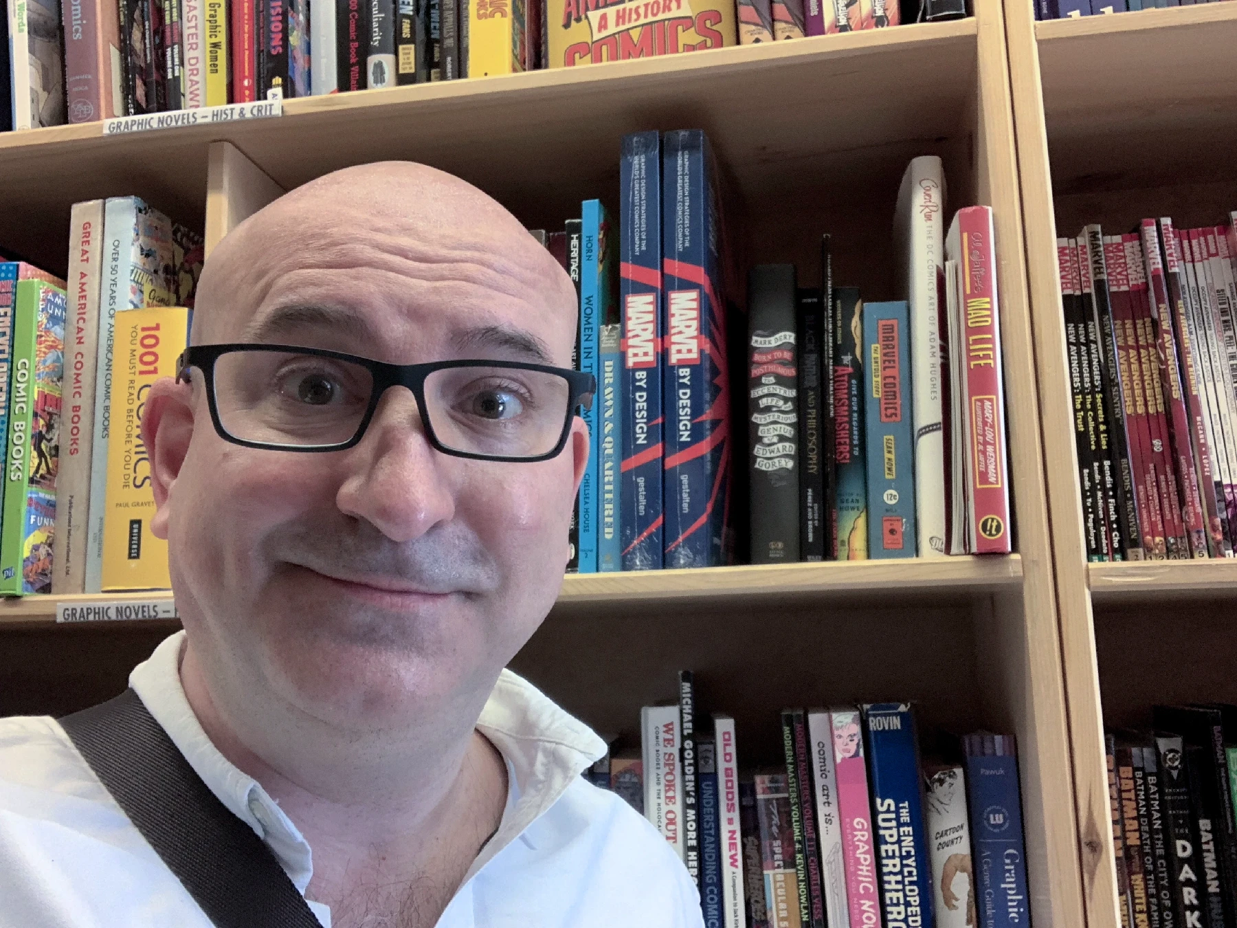 A shot of a book shelf in Powell's bookstore with many Marvel trade paperbacks