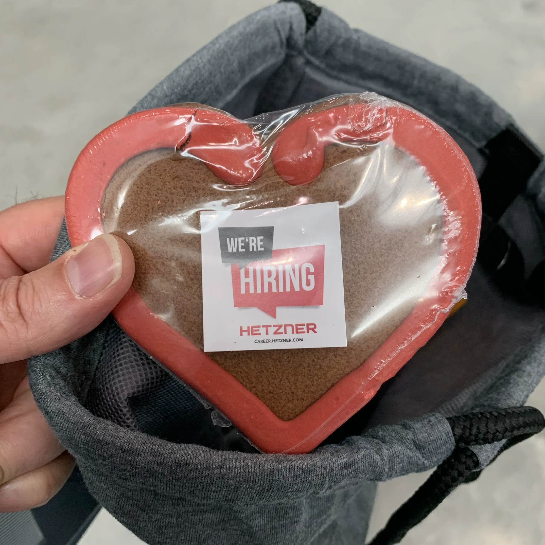 A heart-shaped piece of gingerbread with the word Hiring glazed on it