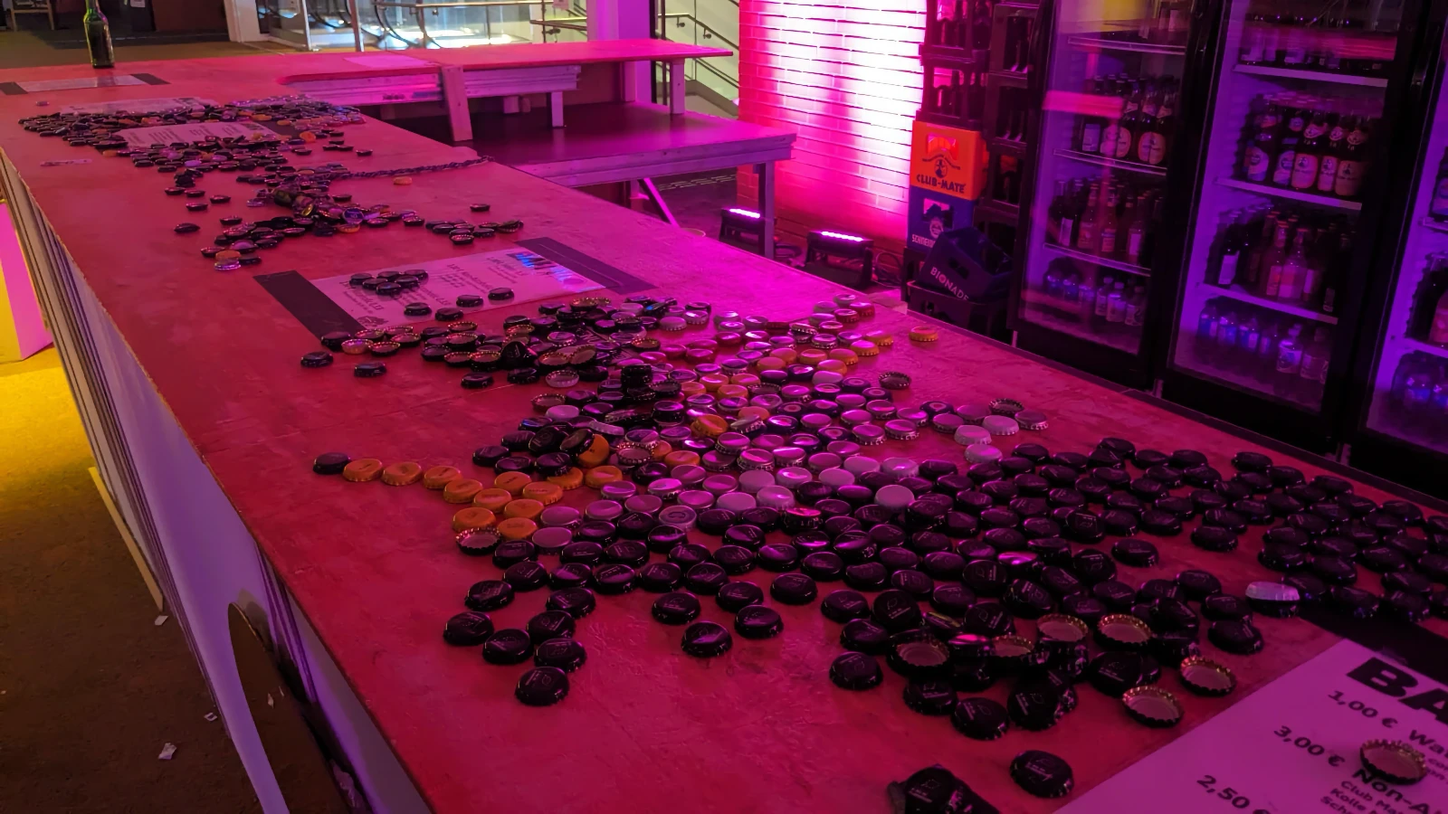 A bar counter full of bottle caps