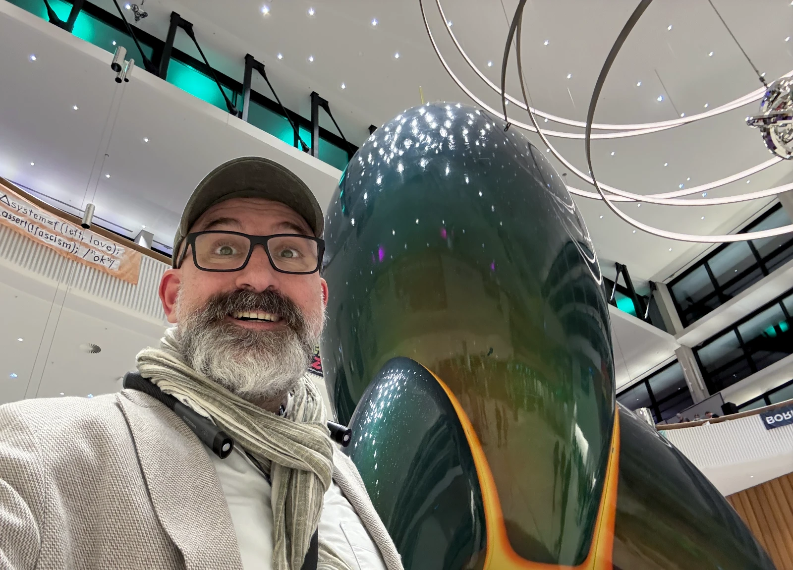 Marin standing in front of the CCC plexi-glass rocket in the entry hallway