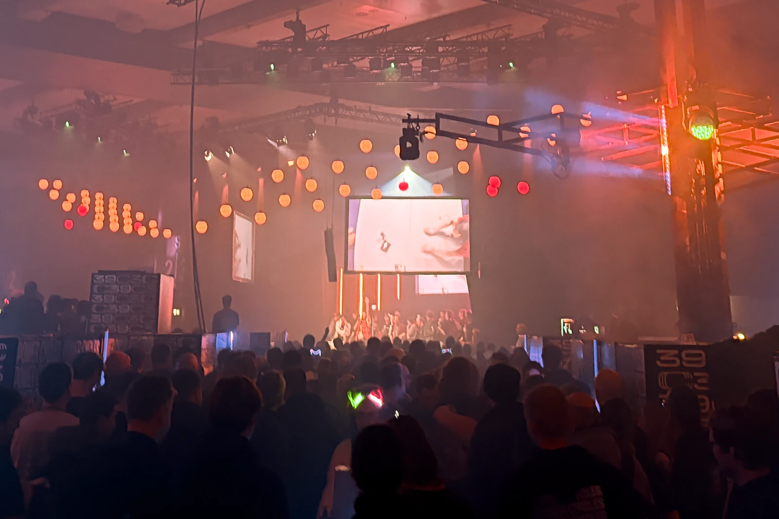 A large crowd watching the shitty robot battle on big screens