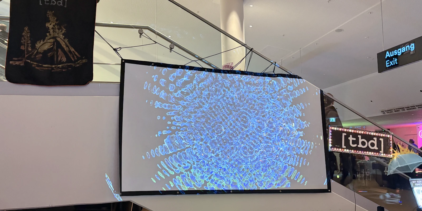 A projection of the light dancing across the water projected onto the wall next to a staircase.