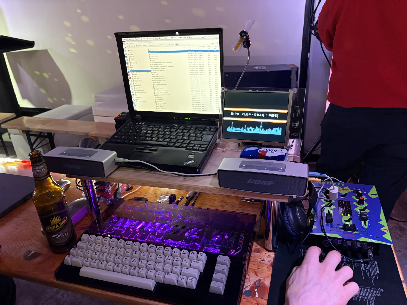 A workstation with a Windows laptop, and a C64 in a new case with a tiny LCD TV attached to it.