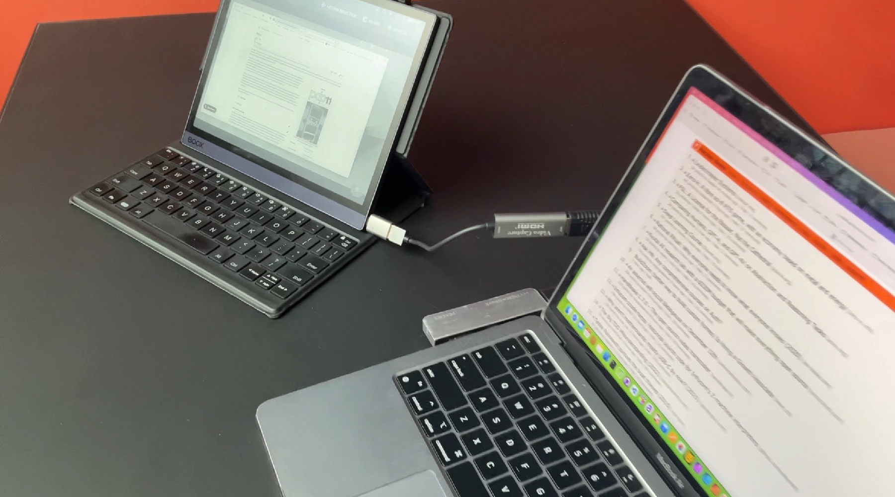 A photo showing an Onyx Boox Tab Ultra connected to a MacBook Air.