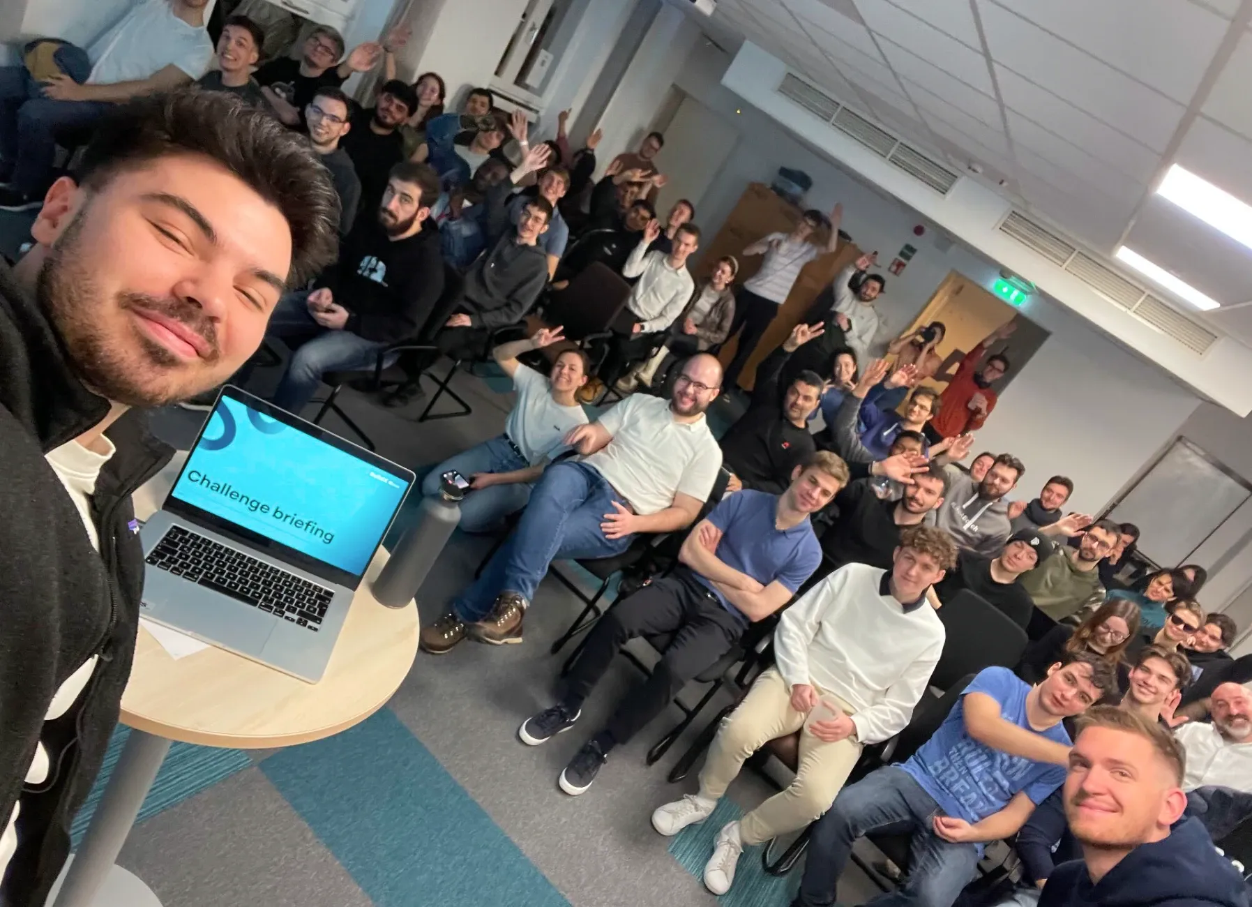 The main organizer of the hackathon taking a group photo of all participants