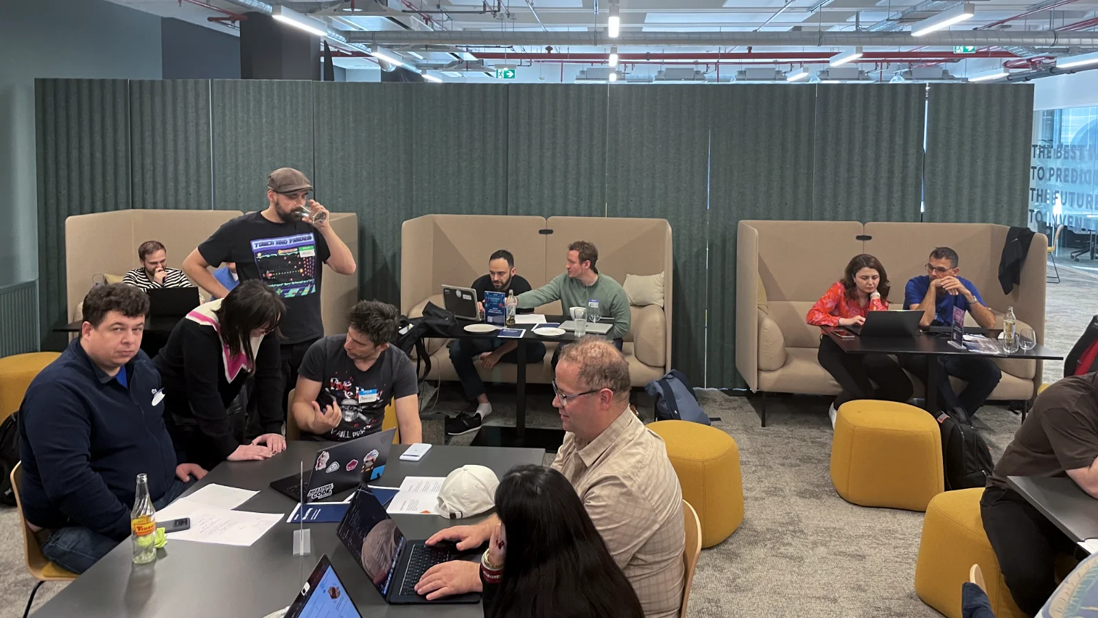 A different perspective of the office with coders sitting at tables