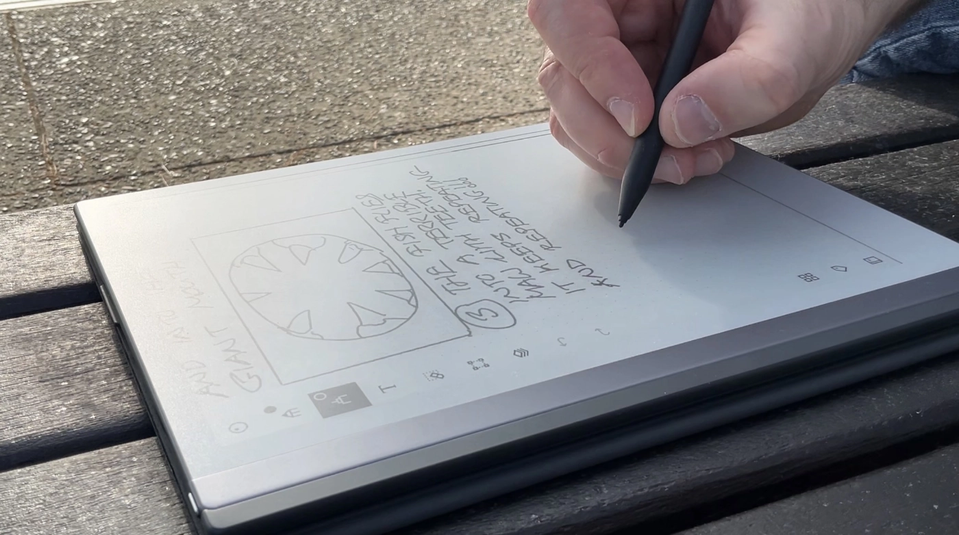 A Remarkable 2 tablet with a hand holding a stylus drawing on it