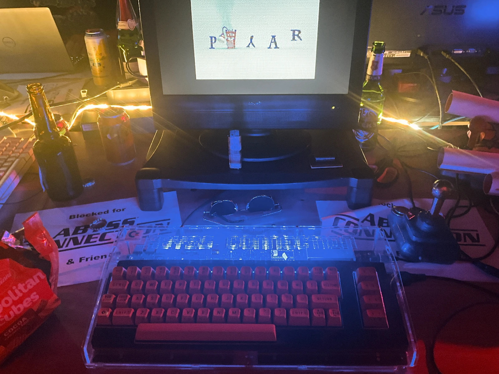 A Commodore 64 in a transparent case at the Abyss Connection table.