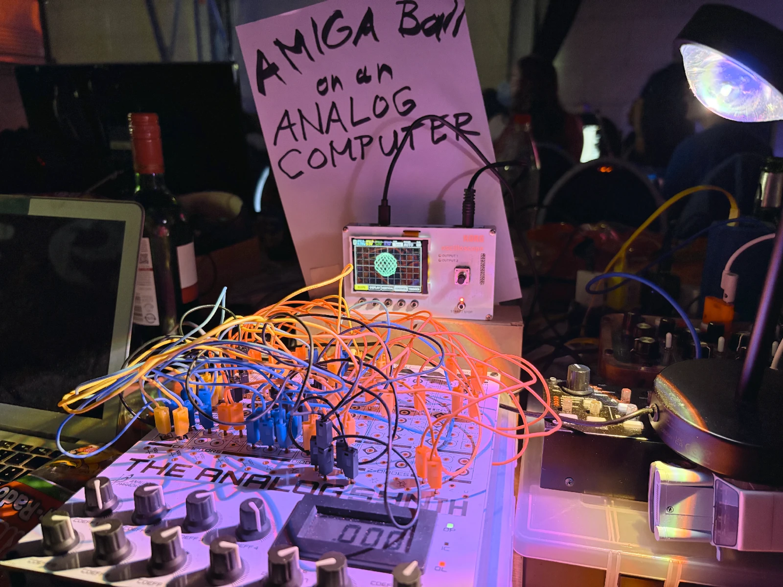 Qetu's analogue synthesizer patched into an oscilloscope displaying a bouncing Amiga Boing Ball.