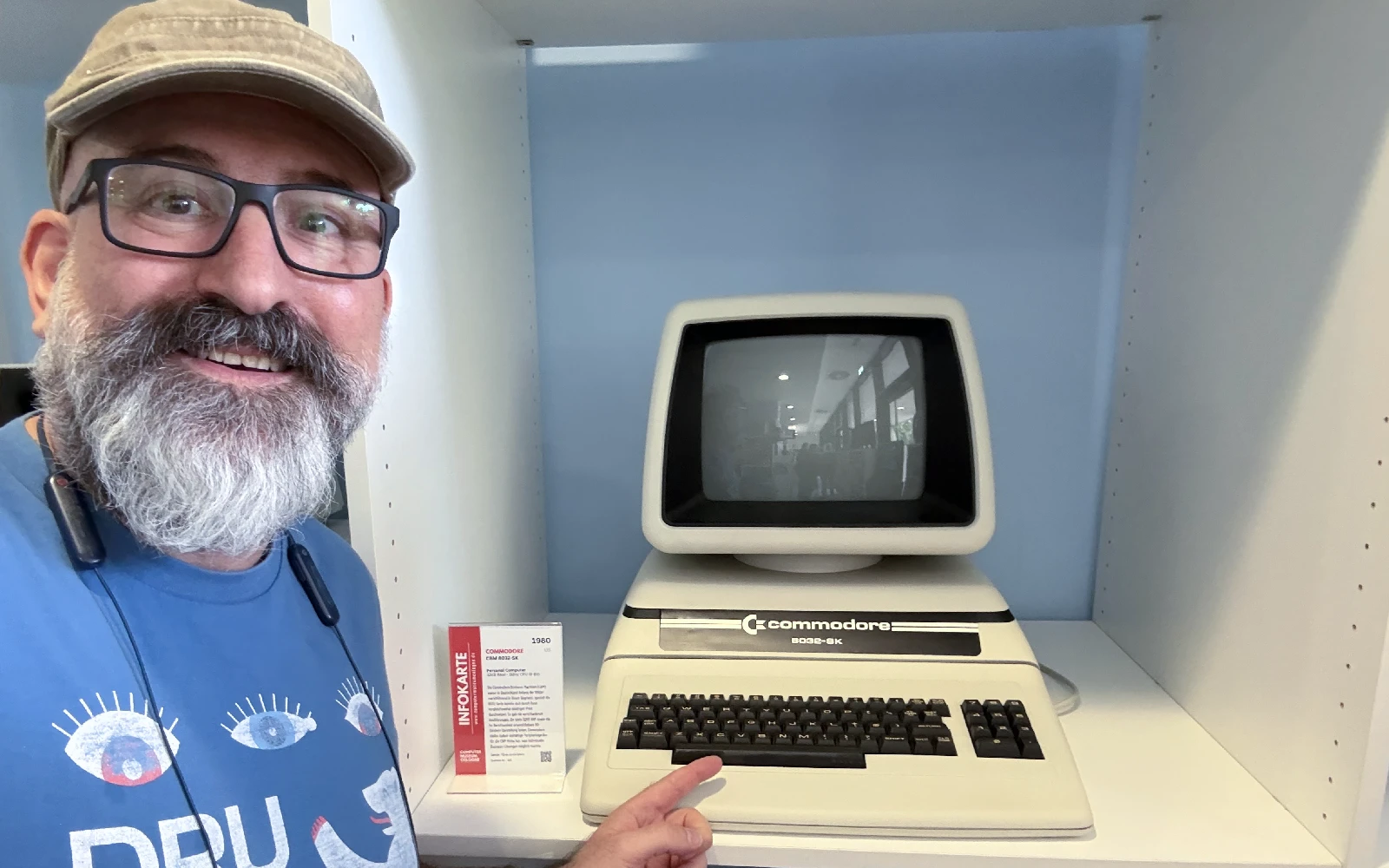 Marin pointing at a Commodore business computer on display.