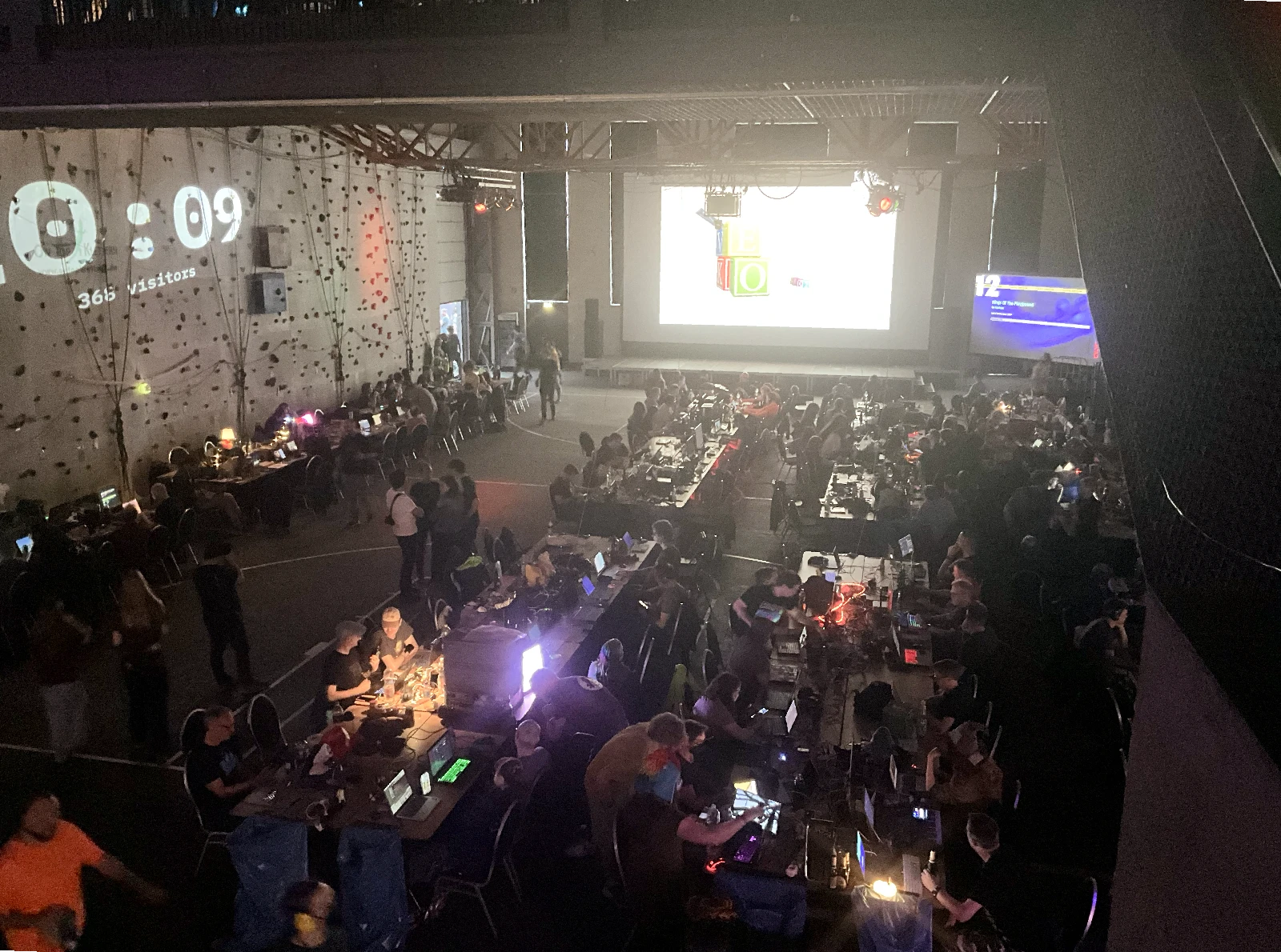 The main hall of the AbenteuerhallenKALK during Evoke 2026, filled with long tables, computers, and hundreds of participants.