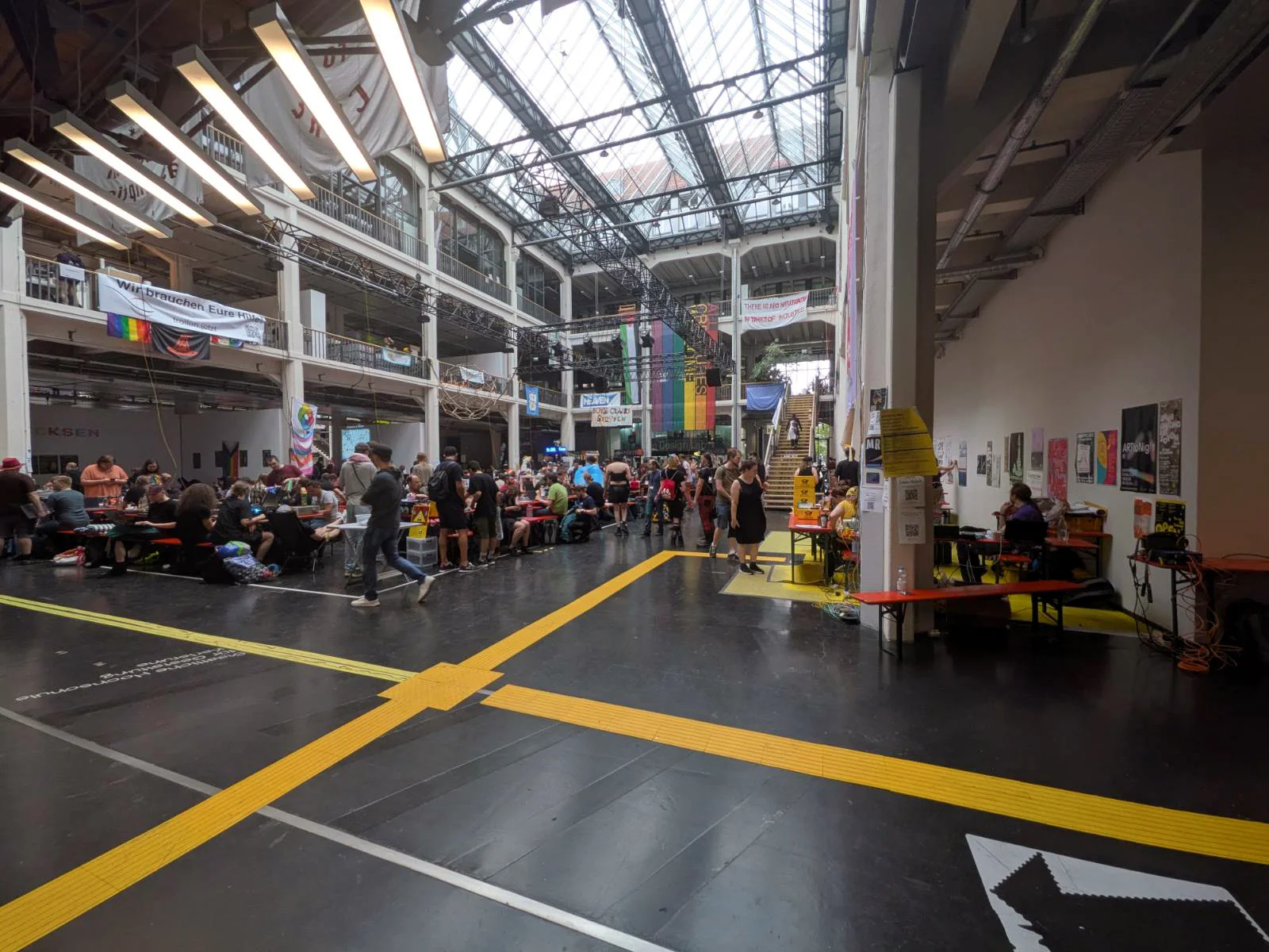 Large industrial hall with yellow floor markings and scattered work areas