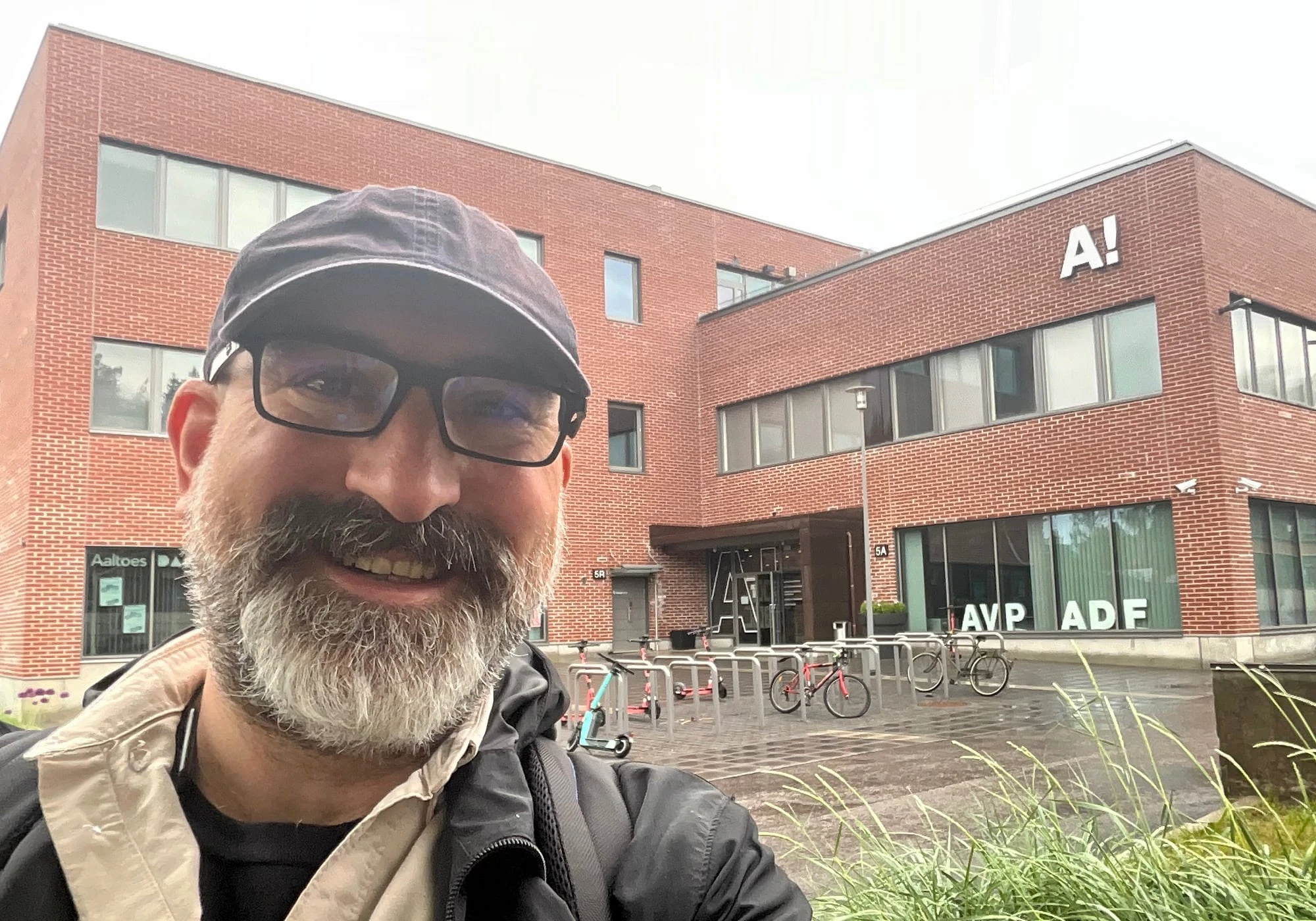 Marin looking into the camera standing in front of the Aalto Design Factory