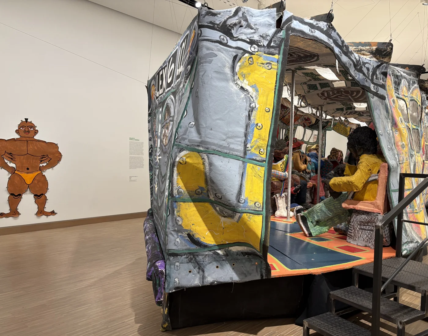 View looking down the interior of the Ruckus Subway car showing benches and cartoon figure cutouts.
