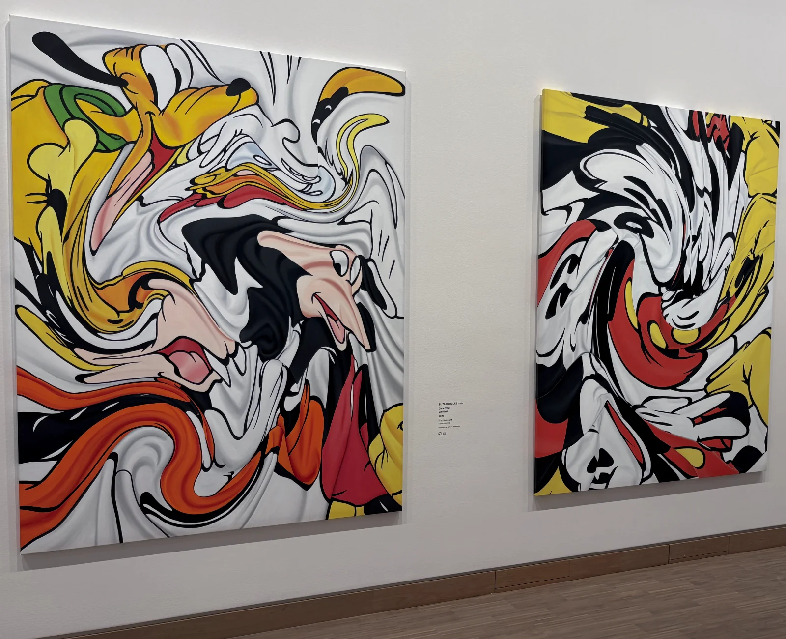 A large canvas painting by Eliza Douglas showing a hand reaching for a cartoon character's head.