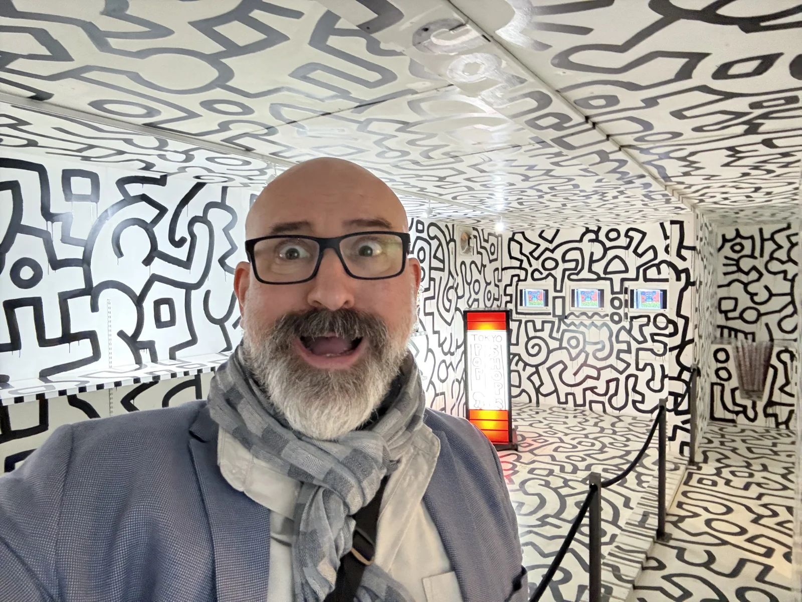 Keith Haring's 'Tokyo Pop' artwork featuring bold black outlines and a simple silhouette figure on a white background.