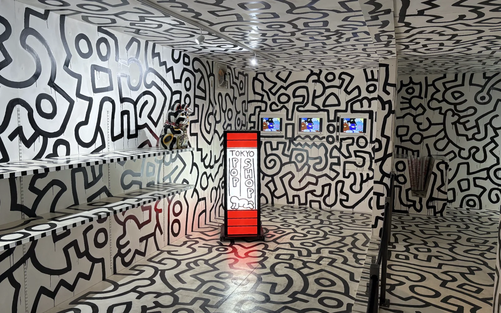 A detail from a Keith Haring piece showing his signature rhythmic line work and stylized figures.