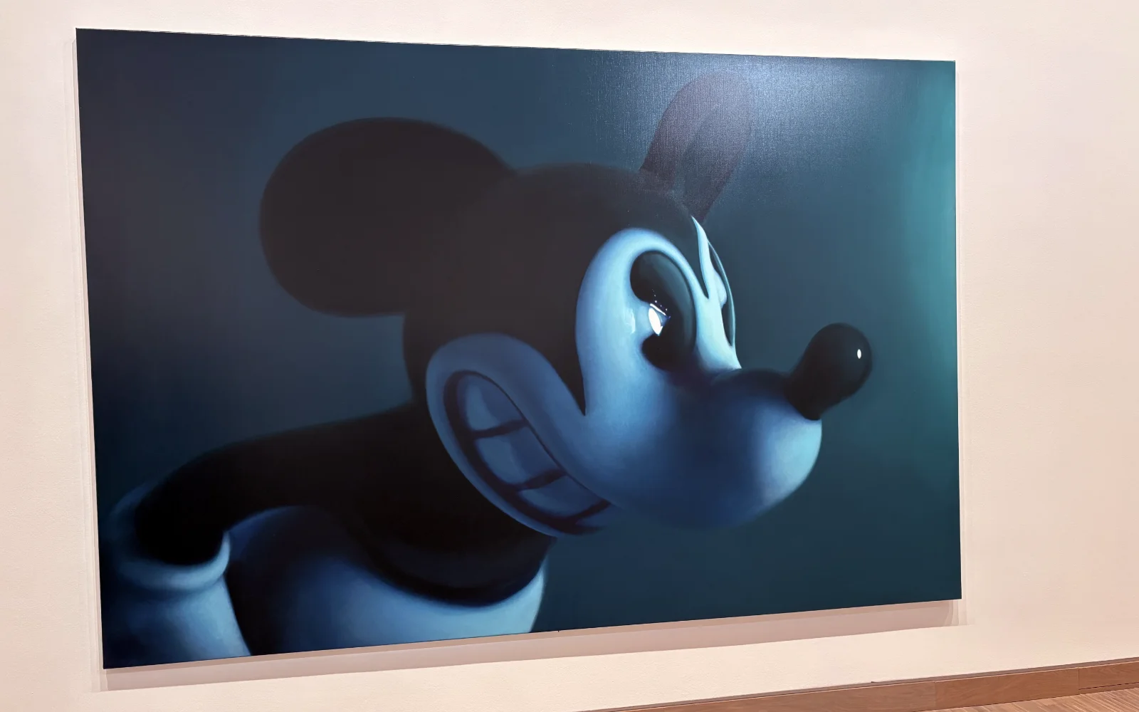 A hyper-realistic, monochromatic painting by Gottfried Helnwein of an aggressive-looking Mickey Mouse.