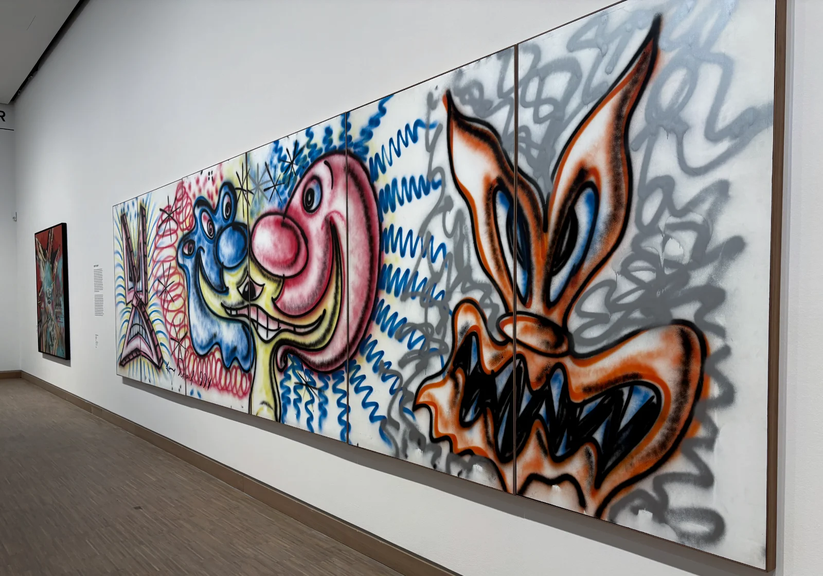 Close-up of Kenny Scharf's artwork showing expressive brushstrokes and bright primary colors.