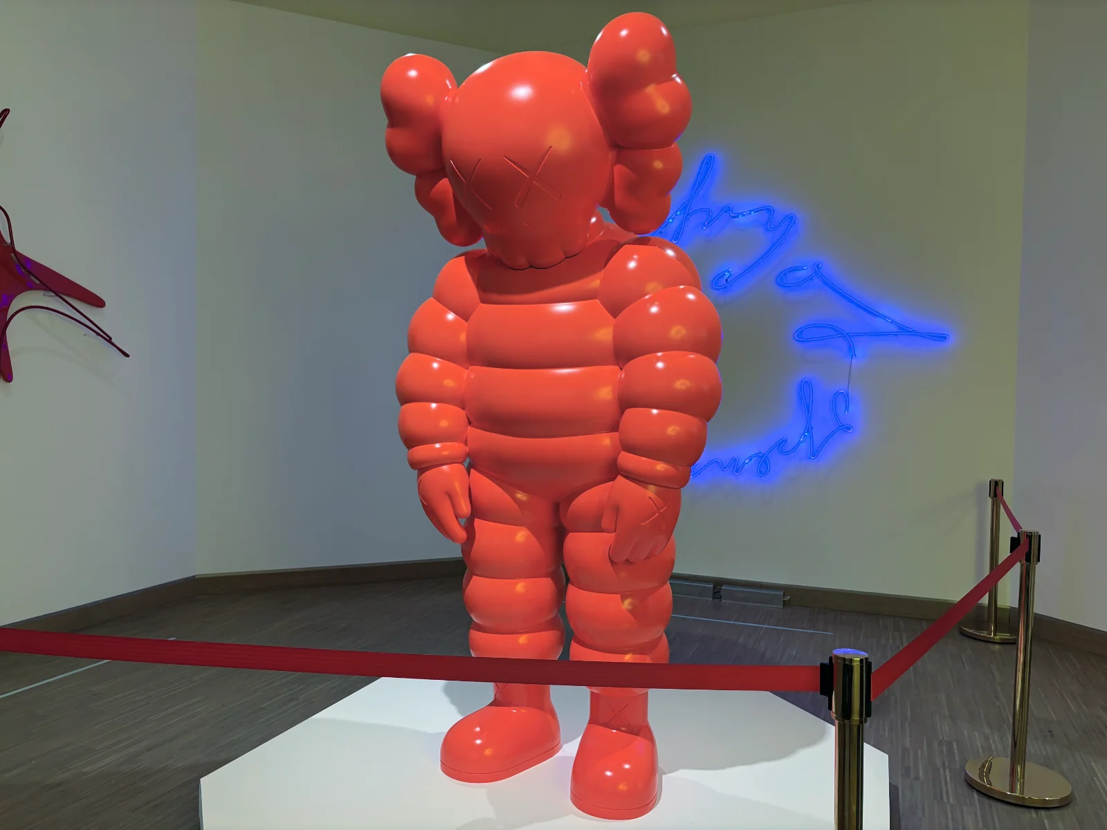 A 3D sculpture of Mickey Mouse with a modern, stylized aesthetic in a gallery setting.