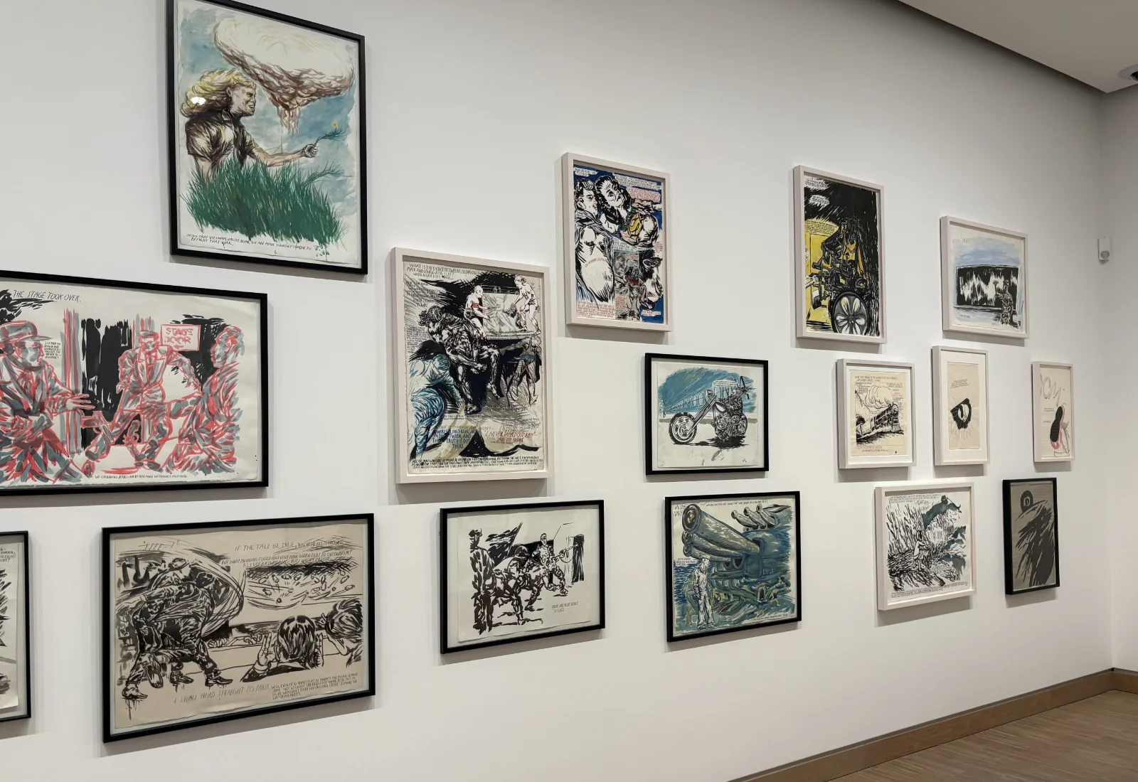 A series of classic comic book panels framed and displayed as a grid on a museum wall.