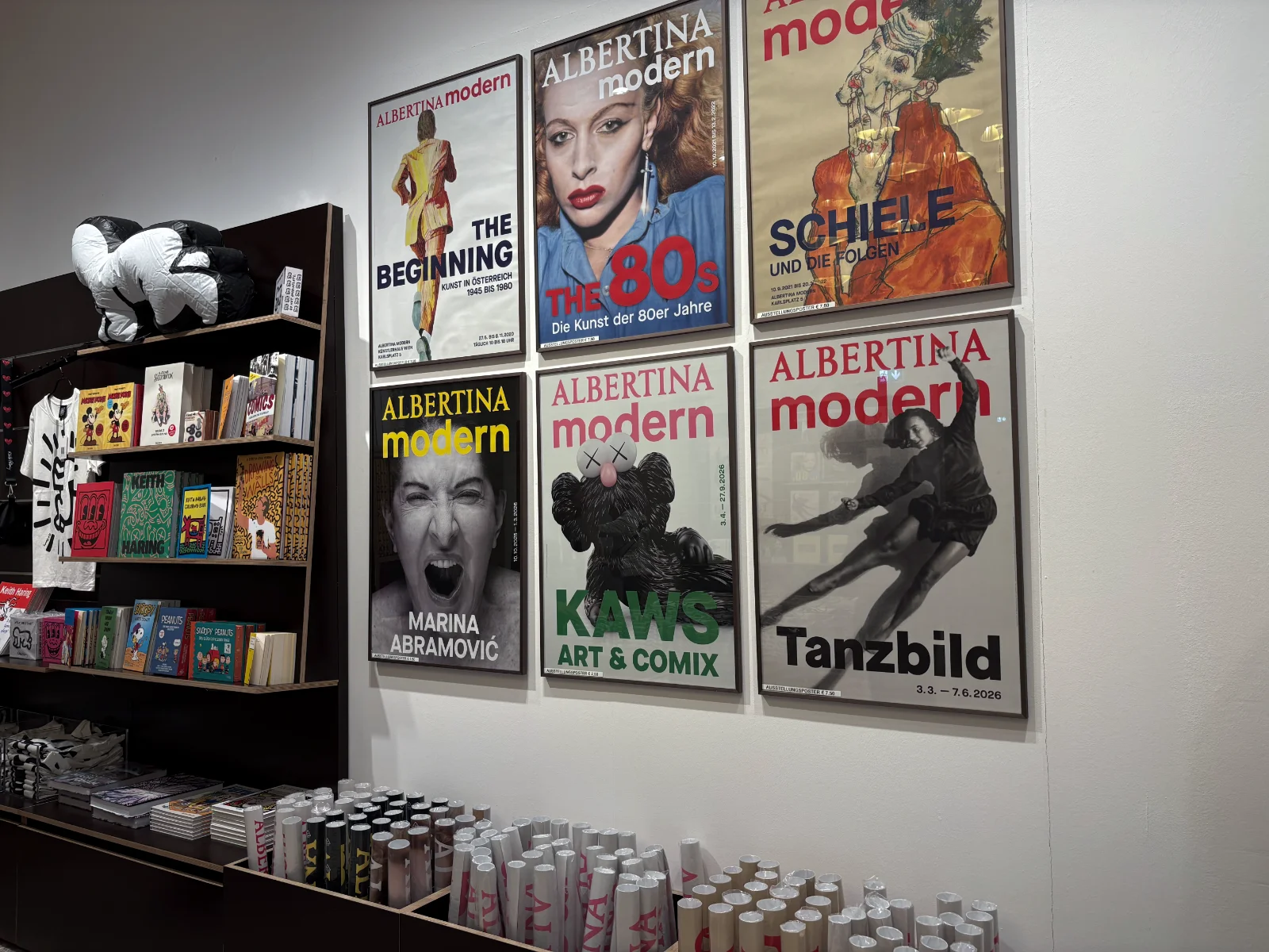 The interior of the Albertina Modern museum shop featuring books and artist-designed merchandise.