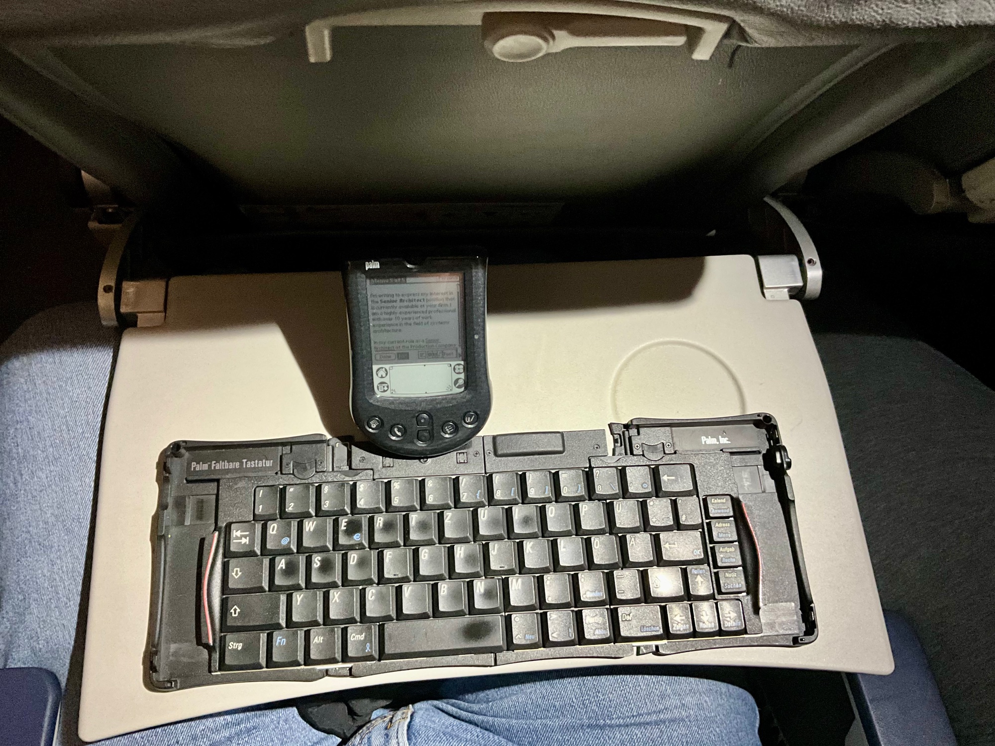 The Palm m125 with the Stowaway keyboard on a tray table during a Ryanair flight