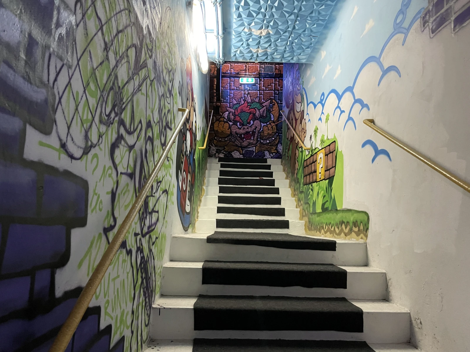 Stairs leading down into the bunker museum with atmospheric lighting.
