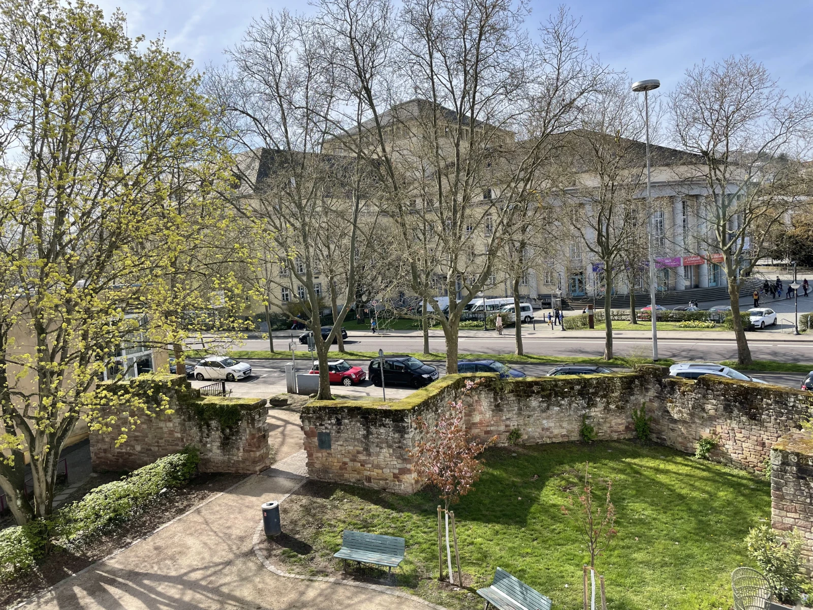 A city view from a hotel room in Saarbrücken with rooftops and urban buildings.