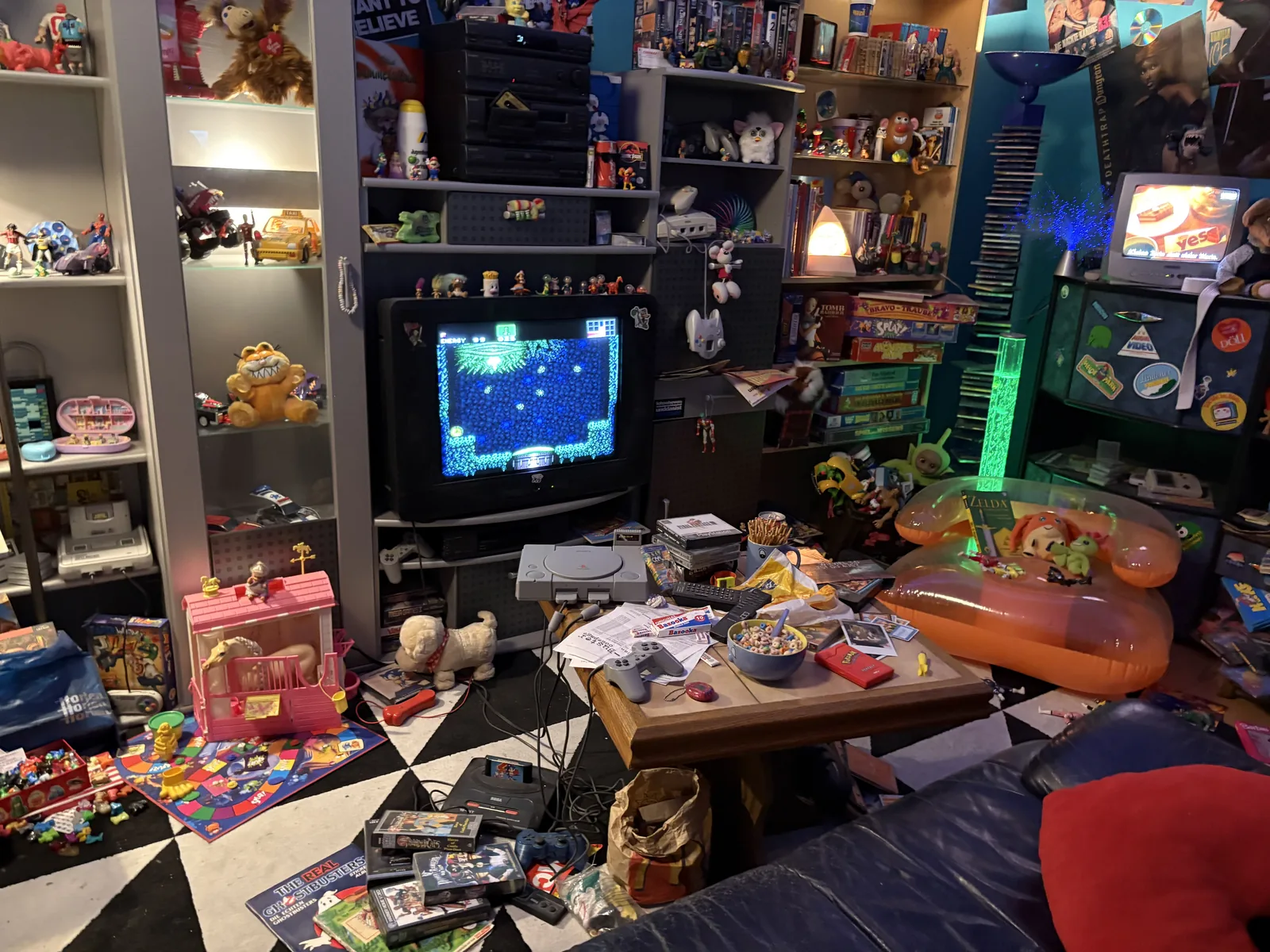 A recreated 1980s kid's bedroom crammed with toys, game boxes, an inflatable chair, and a CRT television showing a game.