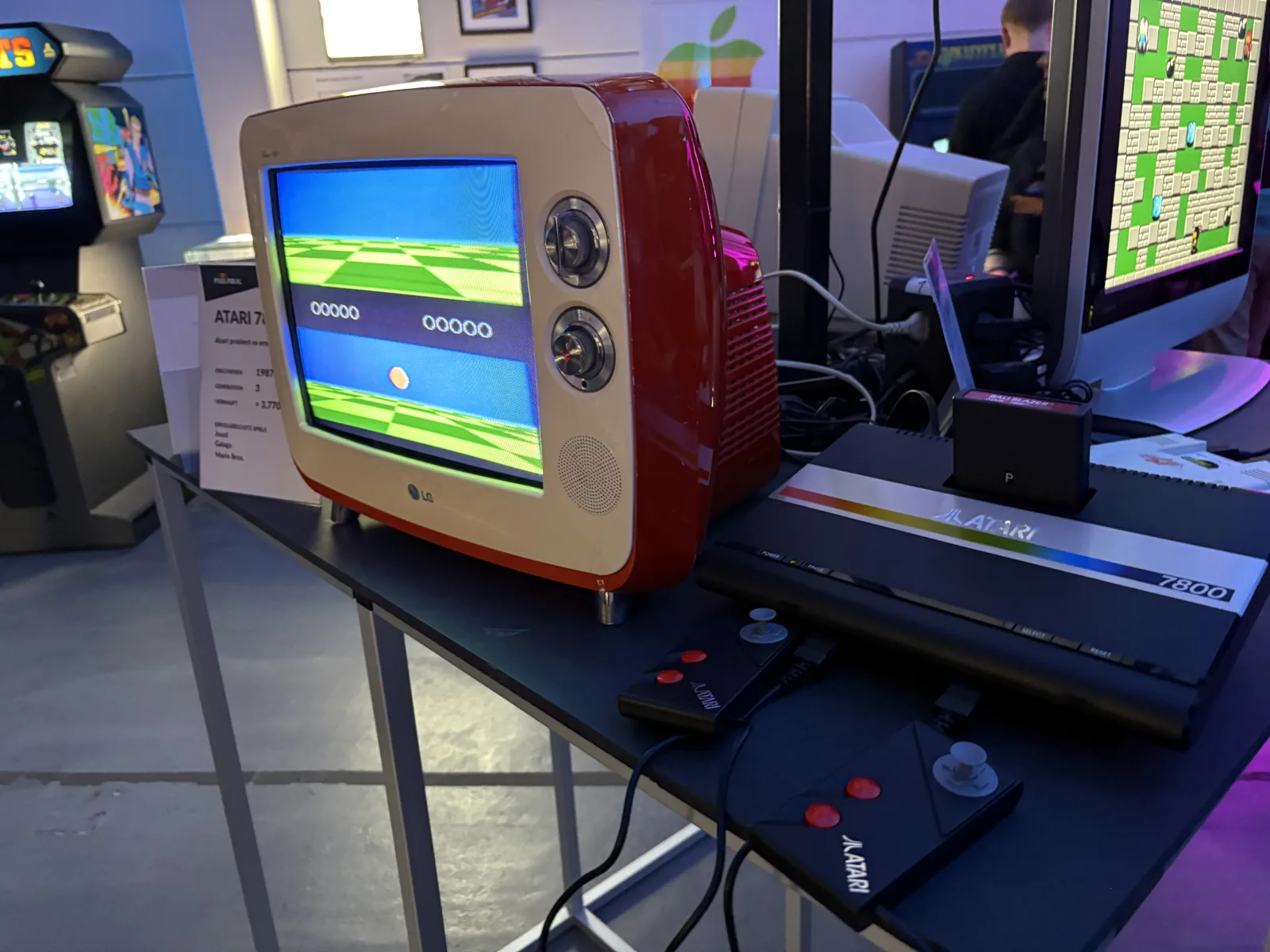 An Atari 7800 console connected to a small red retro-style LG television.